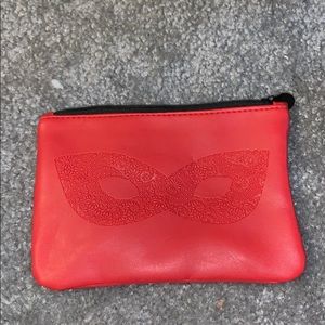 red makeup bag with mask on it